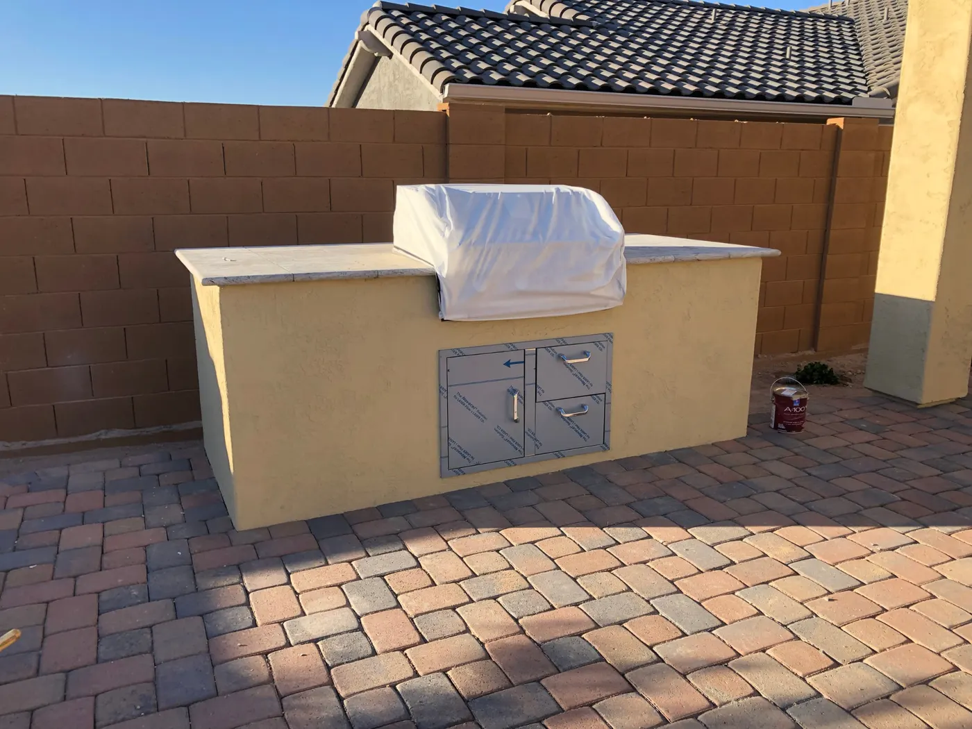 Warm cream painted outdoor kitchen with clean stucco finish